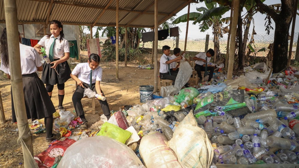 Children are encouraged to bring plastic to school to recycle, instead of burning it – an extremely toxic and dangerous way of heating up [Courtesy of Akshar Forum]