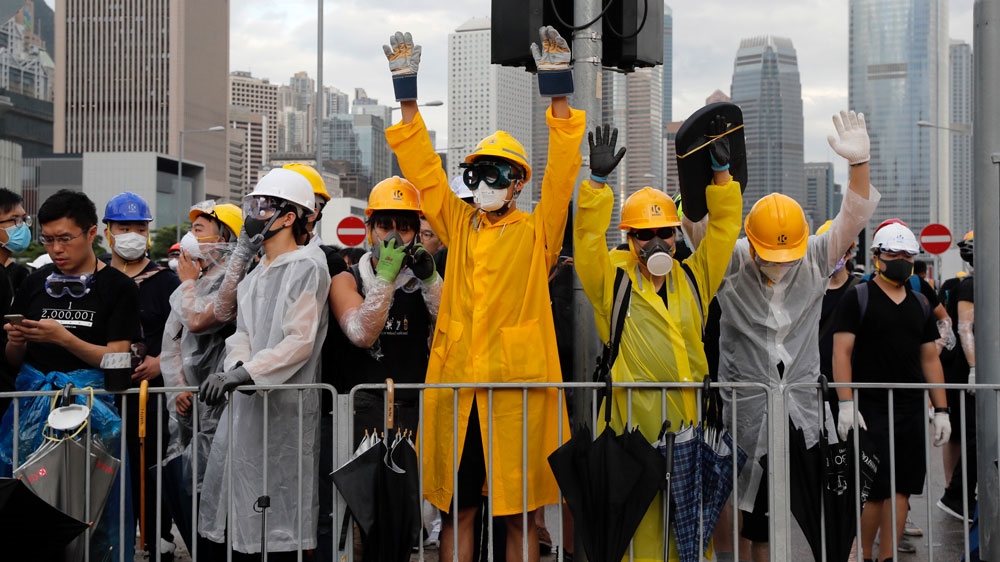 Protesters react to police warnings as they attempt to block a ceremony to mark Hong Kong’s return to Chinese rule in the territory on Monday