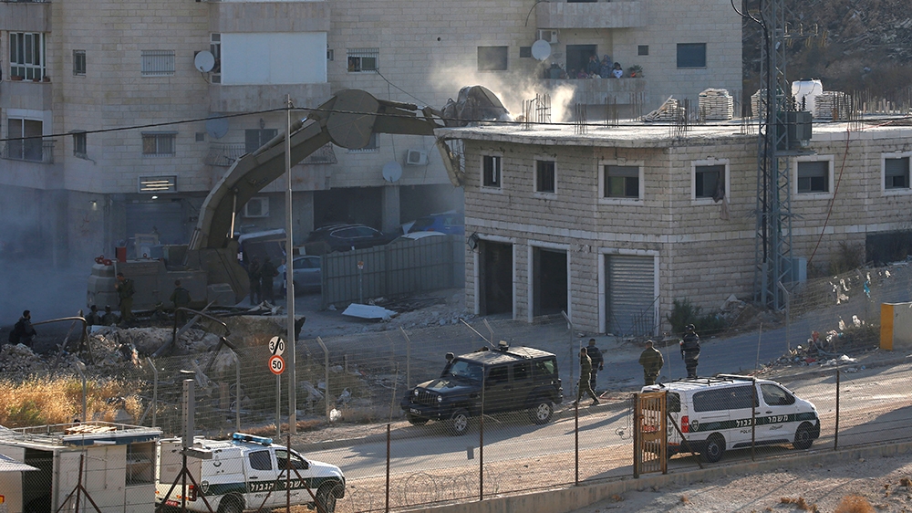 An Israeli machinery demolishes a Palestinian building in the village of Sur Baher which sits on either side of the Israeli barrier in East Jerusalem and the Israeli-occupied West Bank July 22, 2019. 