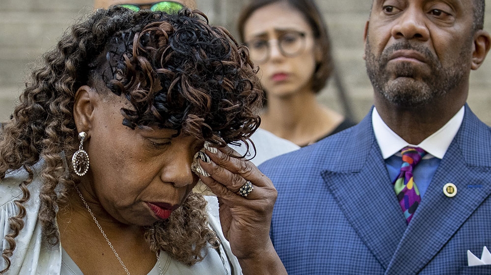 Gwen Carr, mother of the late Eric Garner, wipes away tears after speaking to the press outside the US Attorney’s office following a meeting with federal prosecutors