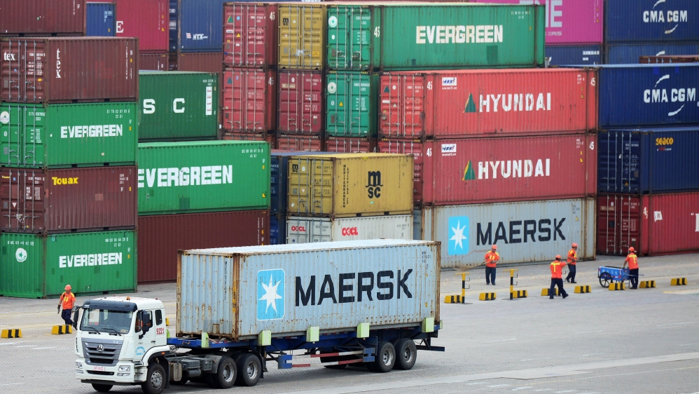 Truck transports a container at a port in Qingdao, Shandong
