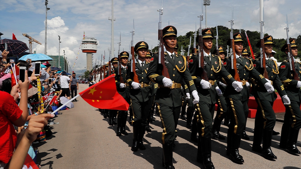 Soldiers from China’s People’s Liberation Army take part in a flag-raising ceremony during an open day of its Stonecutter Island naval base in Hong Kong on Sunday to mark the 22nd anniversary of Hong Kong’s return to Chinese rule