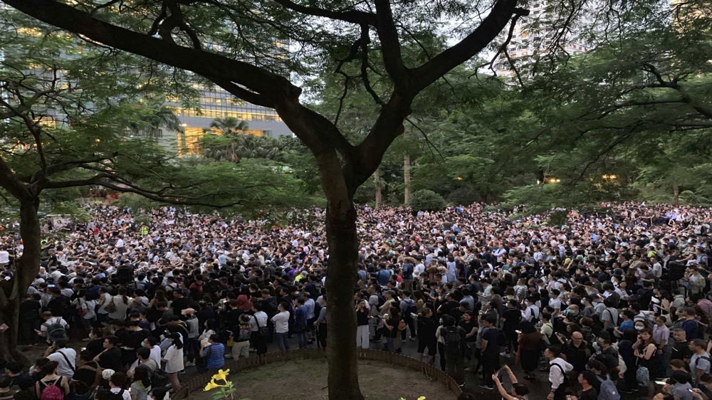 Hong Kong civil servants and protesters cram into a downtown park on Friday