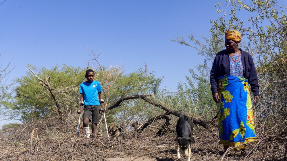Ontebaganye Ngoma, 10, and his grandmother in the area where Ngoma was attacked by an elephant