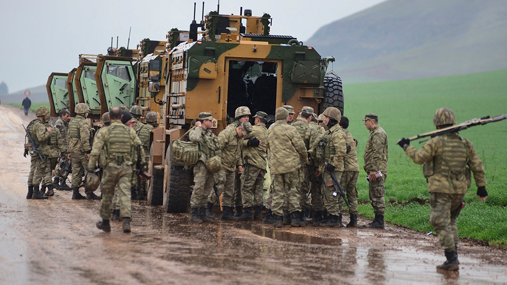 Turkish Army soldiers form a convoy of armoured personnel carriers near the border with Syria, in the outskirts of Hassa, Turkey, Tuesday, Jan. 23, 2018. Turkey''s Foreign Minister Mevlut Cavusoglu has