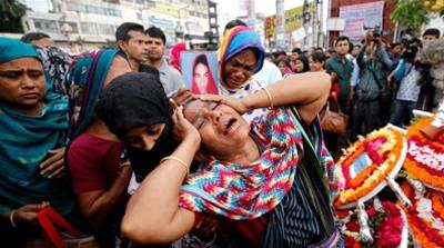 Relatives of people killed in the Rana Plaza building in 2013 mourn at the site during the fourth anniversary of the collapse in Bangladesh