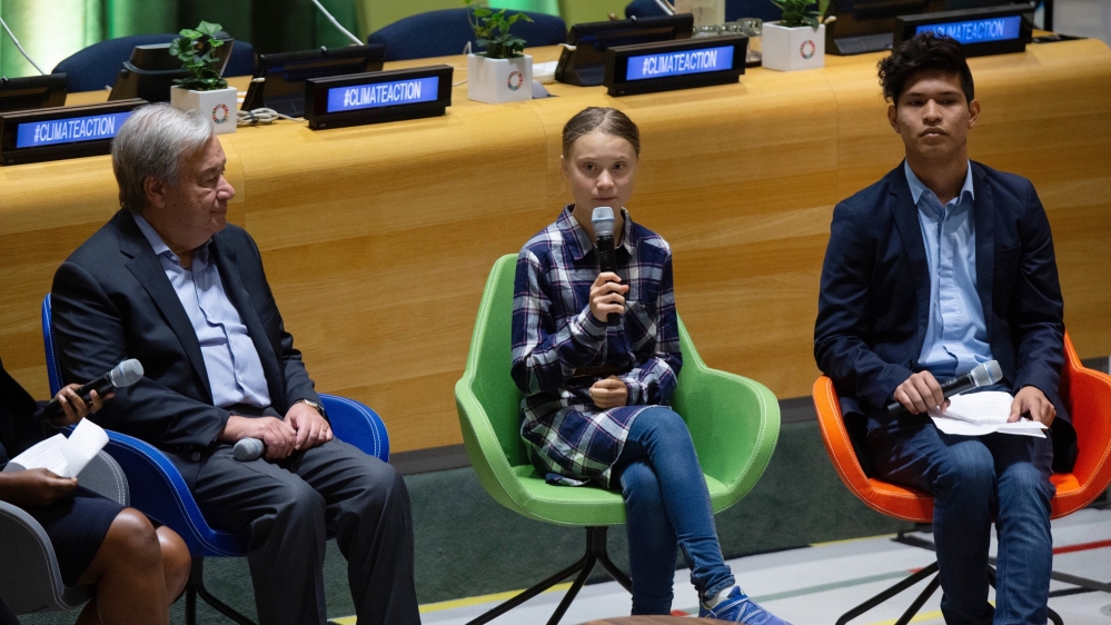 Swedish environmental activist Greta Thunberg, centre, speaks to guests next to UN Secretary-General Antonio Guterres, left, during the Youth Climate Summit at the United Nations headquarters in September