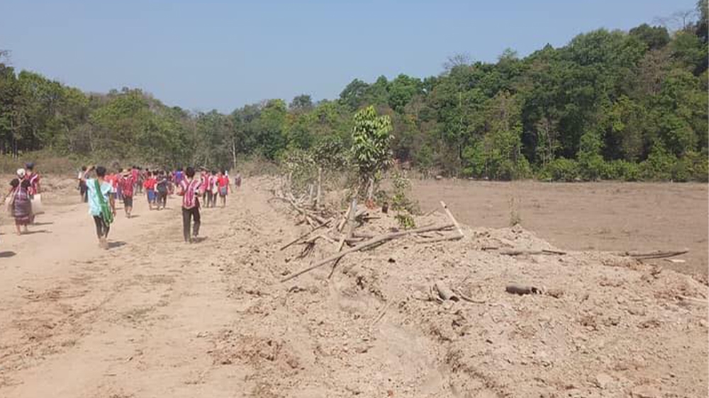 Karen villagers march along the expanded military road in Bago Region in a protest against the project in March