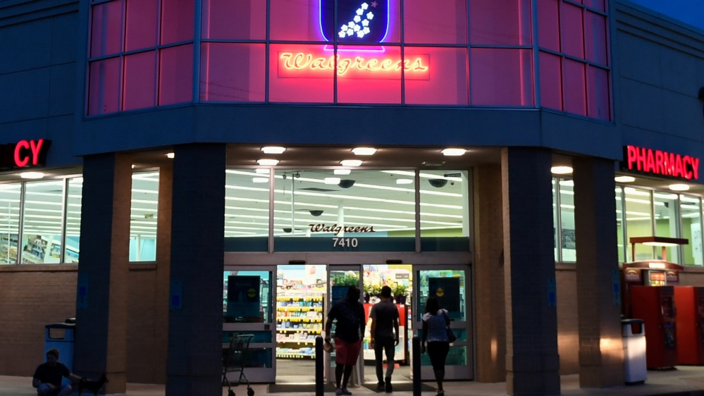 A customer walks out of a Walgreens pharmacy store in Austin, Texas