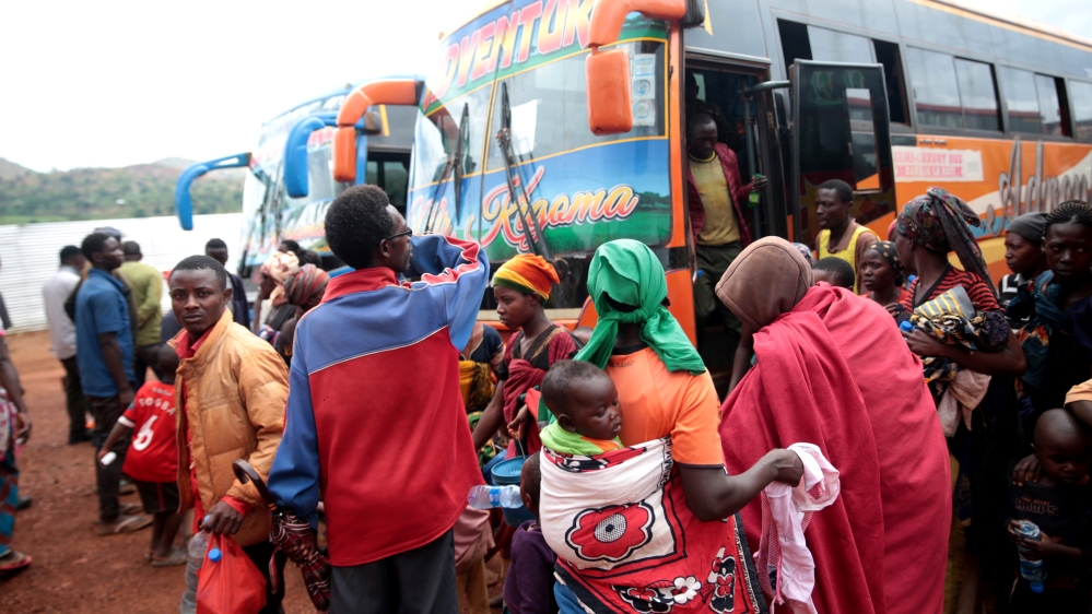 Burundian refugees get off from a bus which transported them from Tanzania to neighbouring Burundi, as part of a repartition program in Burundi