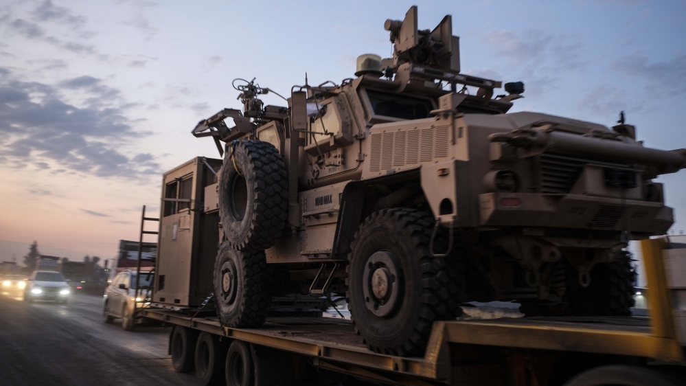 A convoy of US armoured military vehicles leave Syria on a road to Iraq