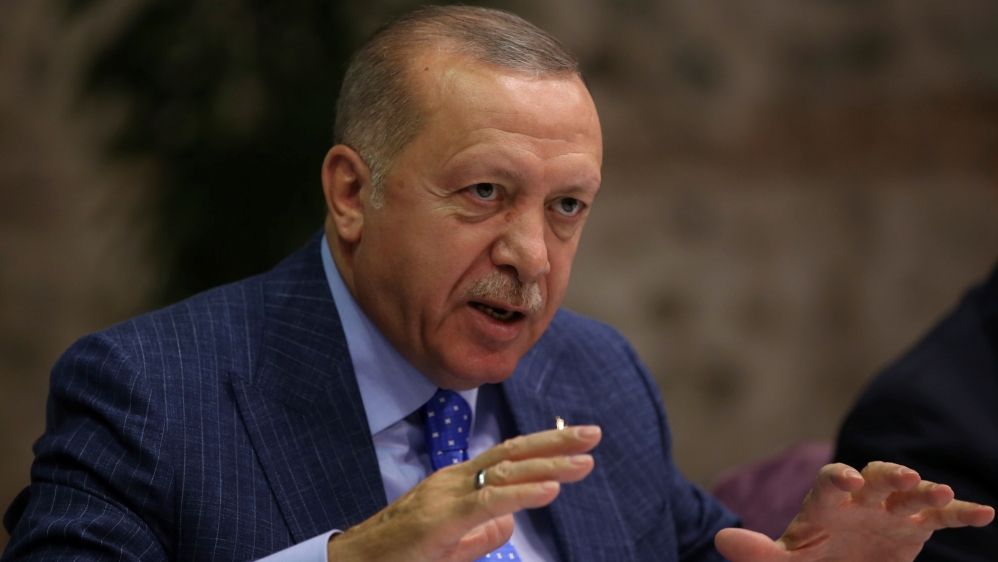 Turkish President Tayyip Erdogan talks to journalists in Istanbul, Turkey, October 13, 2019