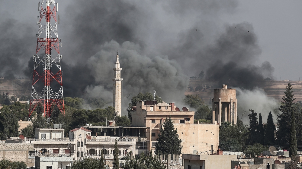 A picture taken from Turkish territory shows smoke rising from targets inside Syria during bombardment by Turkish forces at Ras al-Ein town, as seen from Ceylanpinar, in Sanliurfa, Turkey