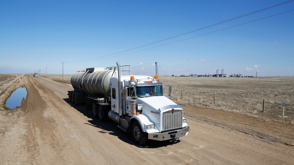A tanker truck used to haul oil products drives away from an oil facility near Brooks