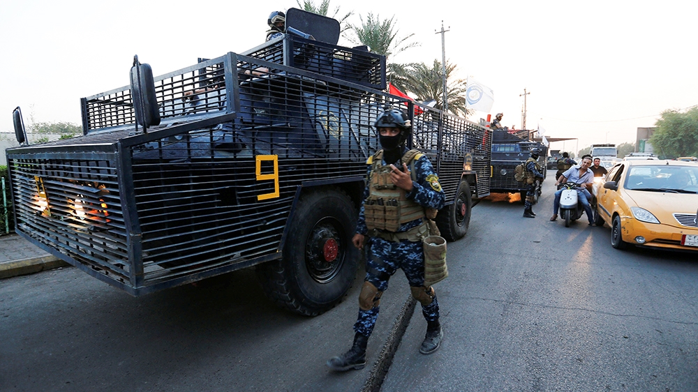 A member of the Iraqi federal police is seen near military vehicles in a street in Baghdad, Iraq October 7, 2019. REUTERS/Wissm al-Okili