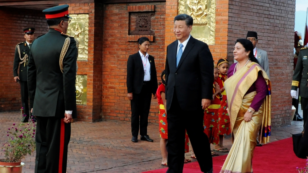 Nepal''s President Bidhya Devi Bhandari walks with China''s President Xi Jinping during a welcome ceremony at the Tribhuvan International Airport in Kathmandu