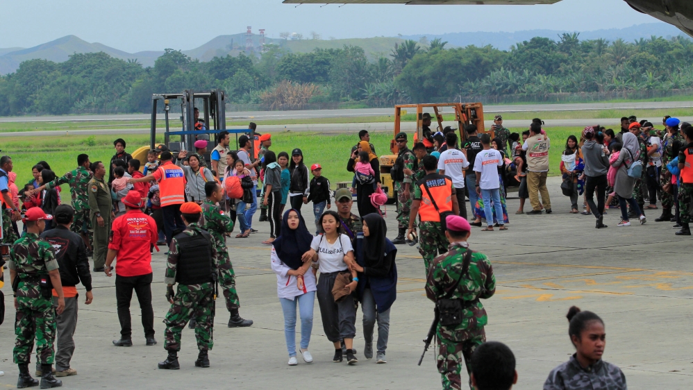 Residents from Wamena arrive with Indonesian military aircraft at Sentani Airport in Jayapura, Papua