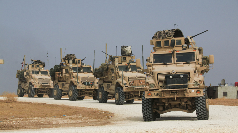 A US military convoy stops near the town of Tel Tamr, north Syria