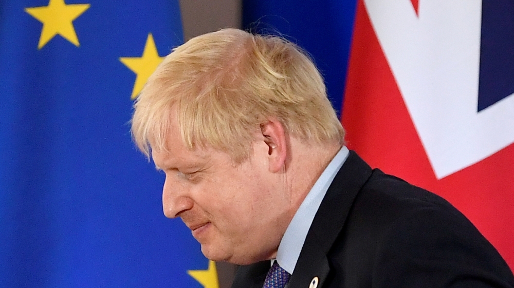 Boris Johnson leaves after attending a news conference at a European Union leaders summit dominated by Brexit, in Brussels, Belgium, in 2019