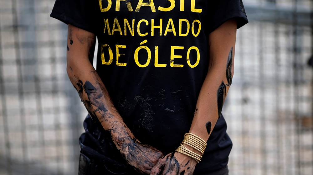 Greenpeace activist stained w/fake oil is seen during a protest against the gov''ts. environmental policies, the oil spill in northeastern states and the environmental situation in the Amazon