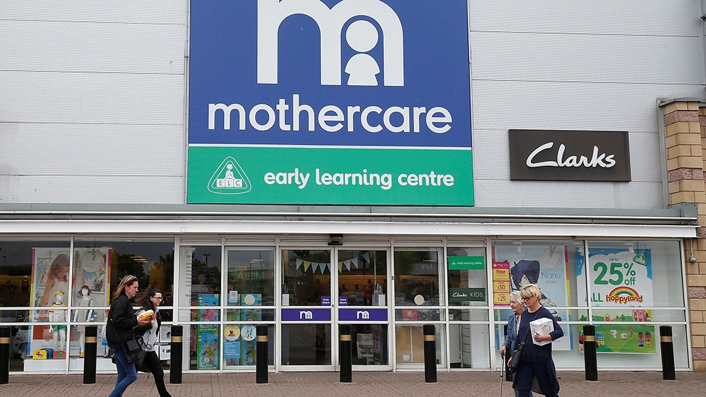 People walk past a Mothercare store in Altricham, Britain, May 16, 201
