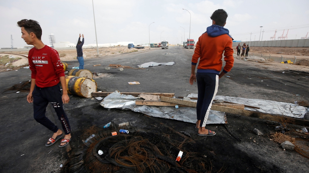 Iraqi demonstrators block the entrance to Umm Qasr Port during the ongoing anti-government protests, south of Basra