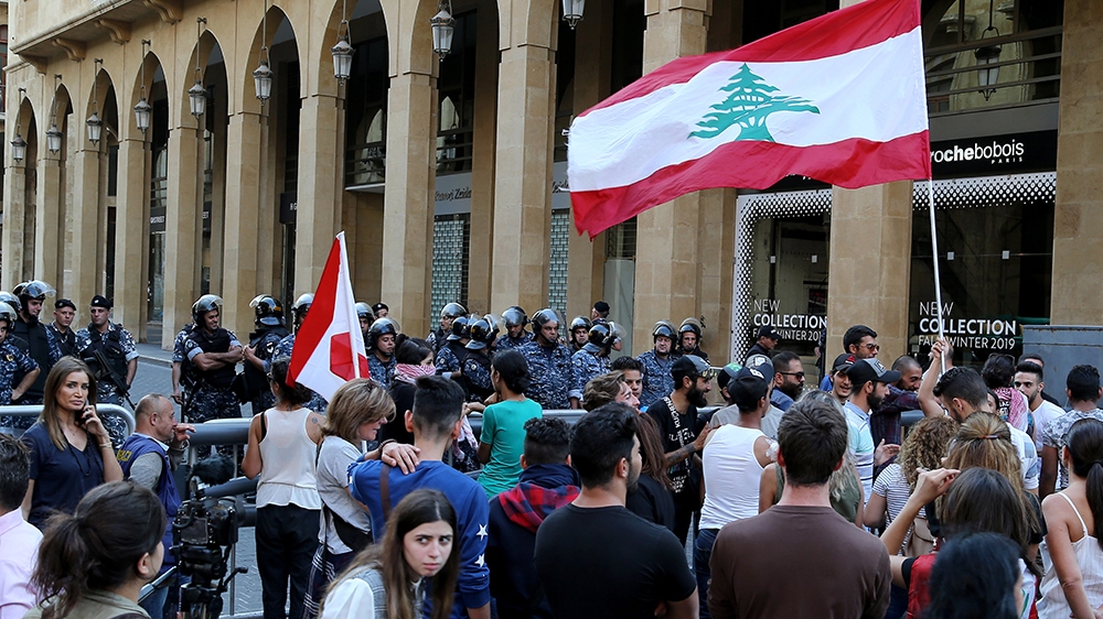 Protesters carry Lebanese flags and shout slogans, in front the entrance of lebanese parliement building during ongoing anti-government protests in downtown in downtown Beirut, Lebanon, 05 November 20