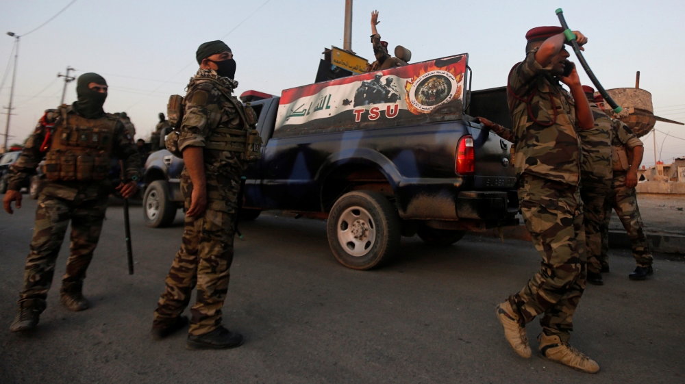 Members of Iraqi security forces are seen during the ongoing anti-government protests in the southern city of Basra