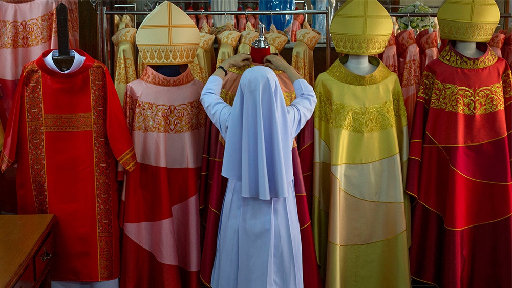 Sister Sukanya Sukchai adjusts newly made chasubles at a Catholic preparatory school in Bangkok in preparation for the visit of Pope Francis who is due to arrive in the country this week.