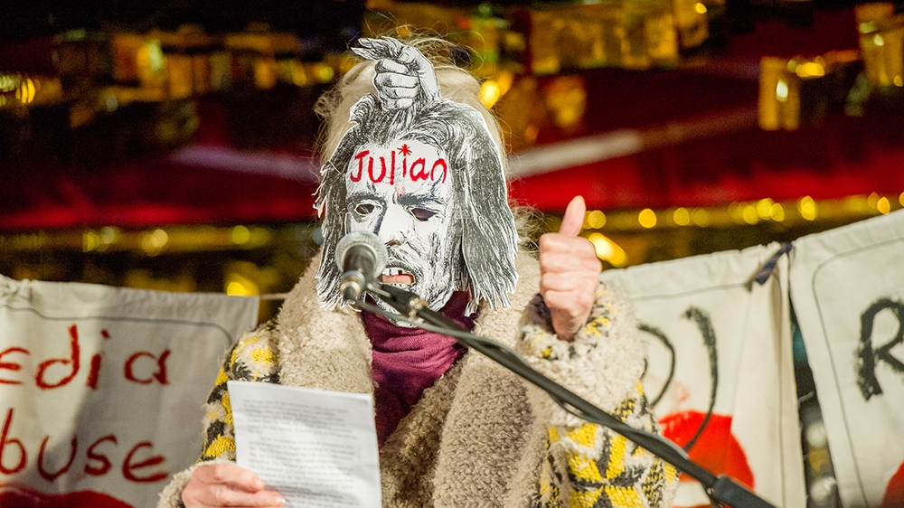 Vivienne Westwood surrounded by banners and wearing a Julian Assange mask of her own creation at a protest event outside of The Home Office on November 5, 2019 in London, UK