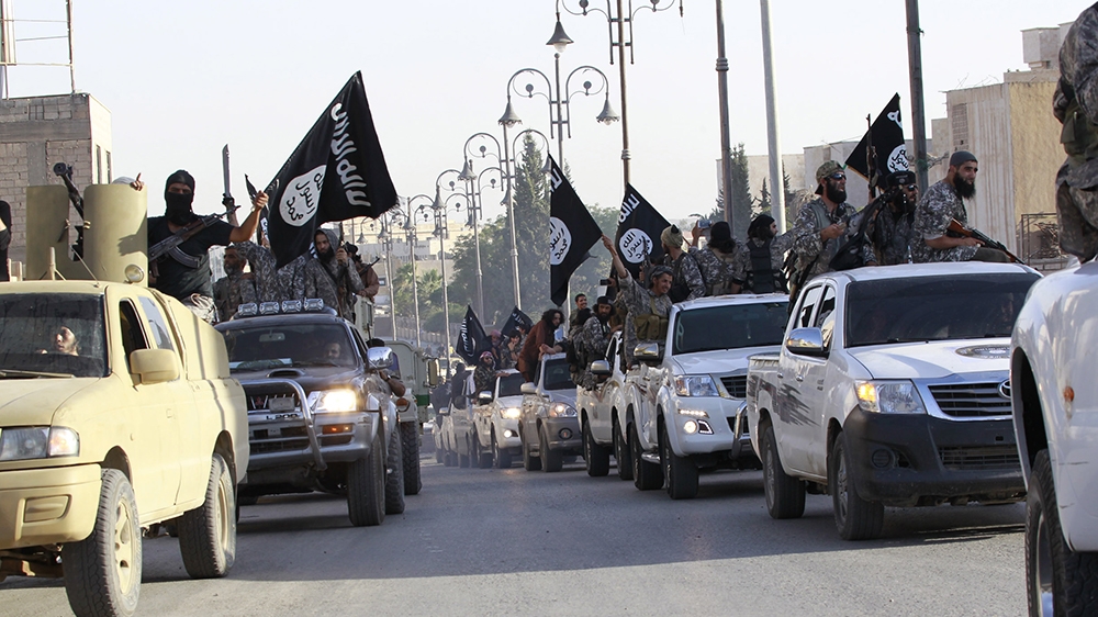 Militant Islamist fighters parade on military vehicles along the streets of northern Raqqa province June 30, 2014. Militant Islamist fighters held a parade in Syria''s northern Raqqa province to celebr
