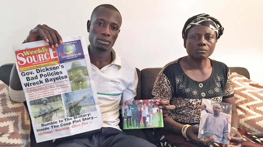 Abiri Angatimi Kenneth and Toboulayefa Jones hold photographs of their imprisoned father and husband, Jones Abiri, along with the last edition of his newspaper, published before he was imprisoned in 2016 for two years without trial. Abiri was released in August 2018, but rearrested in May 2019, charged in federal court, and released on bail in October