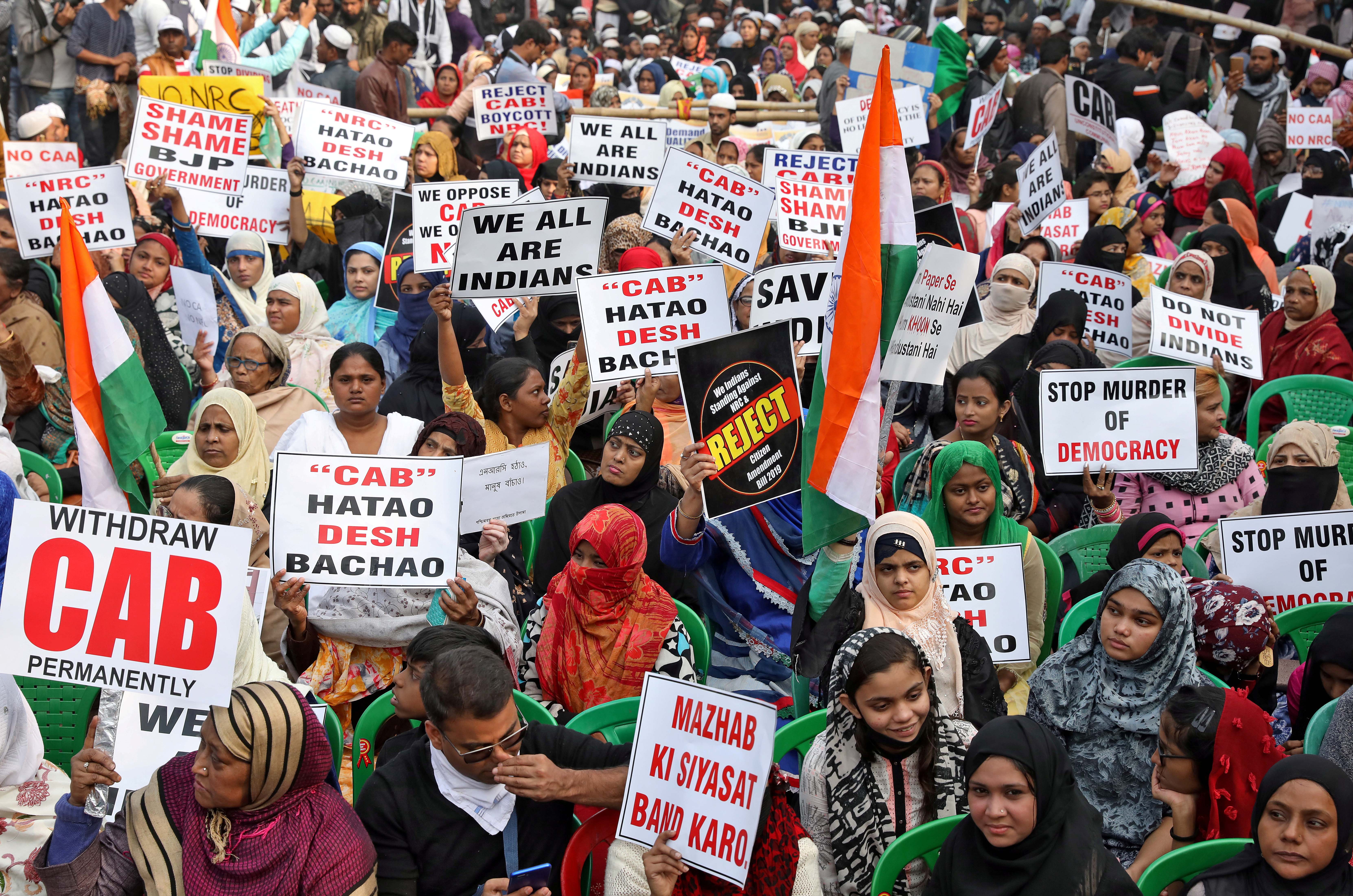 Women display placards during a protest in Kolkata on December 22, 2019 [Reuters]