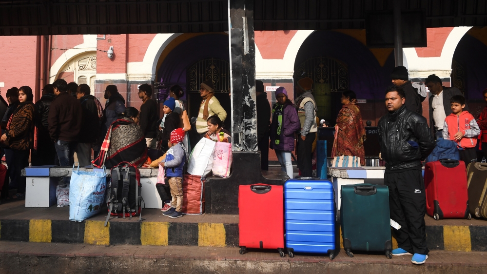 People wait for transportation outside the Howrah railway station during a nationwide general strike called by trade unions aligned with opposition parties to protest the Indian government''s economic