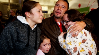Fernando Arredondo from Guatemala reunites with his daughters Andrea, left, Keyli, right, and Alison, second from left, at Los Angeles International Airport after being separated during the Trump administration’s wide-scale separation of immigrant families