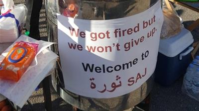Marc Darido and Rudy Hanna, two professionals with degrees, opened a flatbread stand – Thawra Saj – that sports a sign reading ‘we won’t give up’