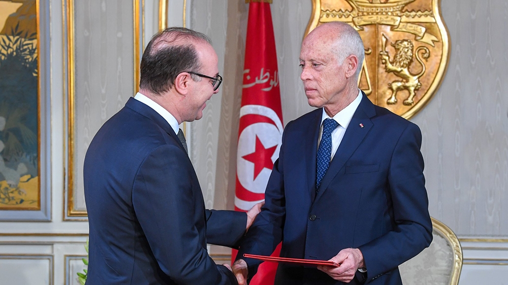 Tunisian President Kais Saied (R) gives letter of tasking to Tunisian former Finance Minister Elyes Fakhfakh (L) to form new government at the Carthage Palace in Tunis, Tunisia on January 21, 2020. (