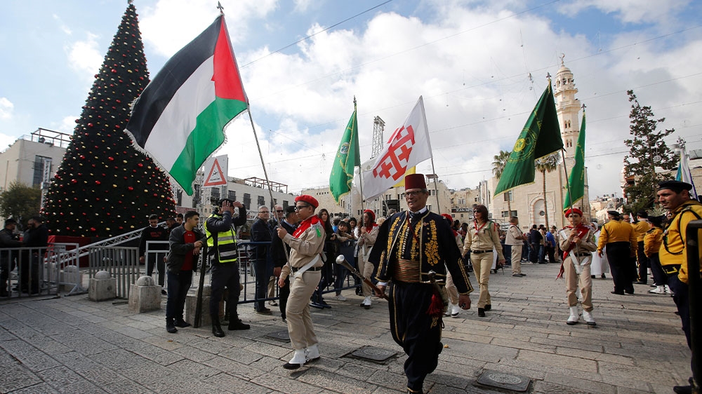 Palestinian scouts parading in Manger Square outside the Church of the Nativity in Bethlehem, in the occupied West Bank