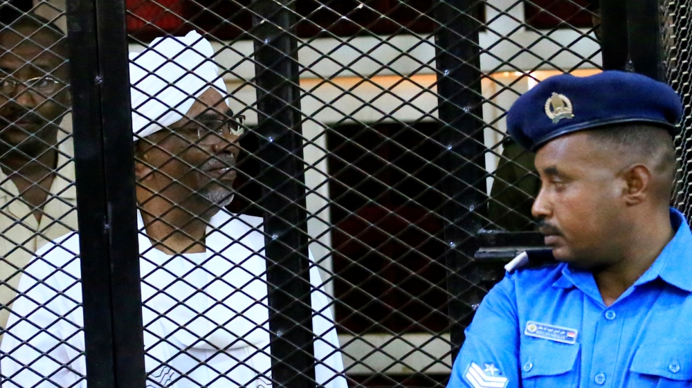 Sudan''s former president Omar Hassan al-Bashir sits inside a cage during the hearing of the verdict that convicted him of corruption charges in a court in Khartoum