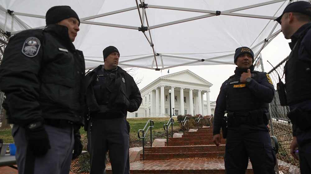 Law enforcement officers manage a security checkpoint to access the Virginia State Capitol grounds before a gun rights advocates and militia members rally in Richmond, Virginia