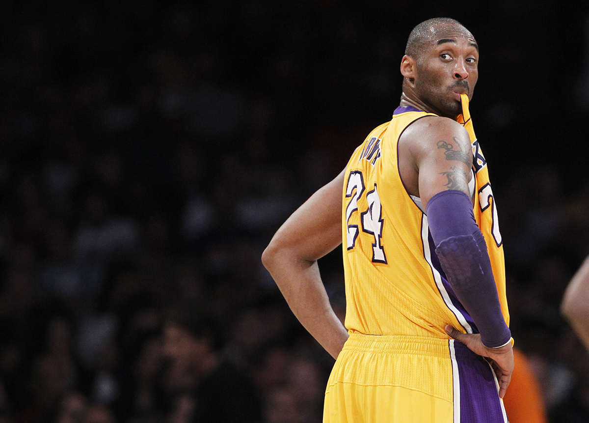 Los Angeles Lakers'' Kobe Bryant chews on his jersey as he turns around to listen to coach Mike Brown during the first half of an NBA basketball game against the New York Knicks in Los Angeles December