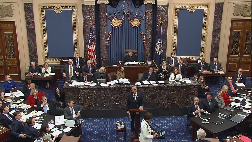 Lead manager House Intelligence Committee Chairman Adam Schiff (D-CA) delivers an opening argument as Senate Majority Leader Mitch McConnell (R-KY) (lowerR) prepares to speak during the second day of 