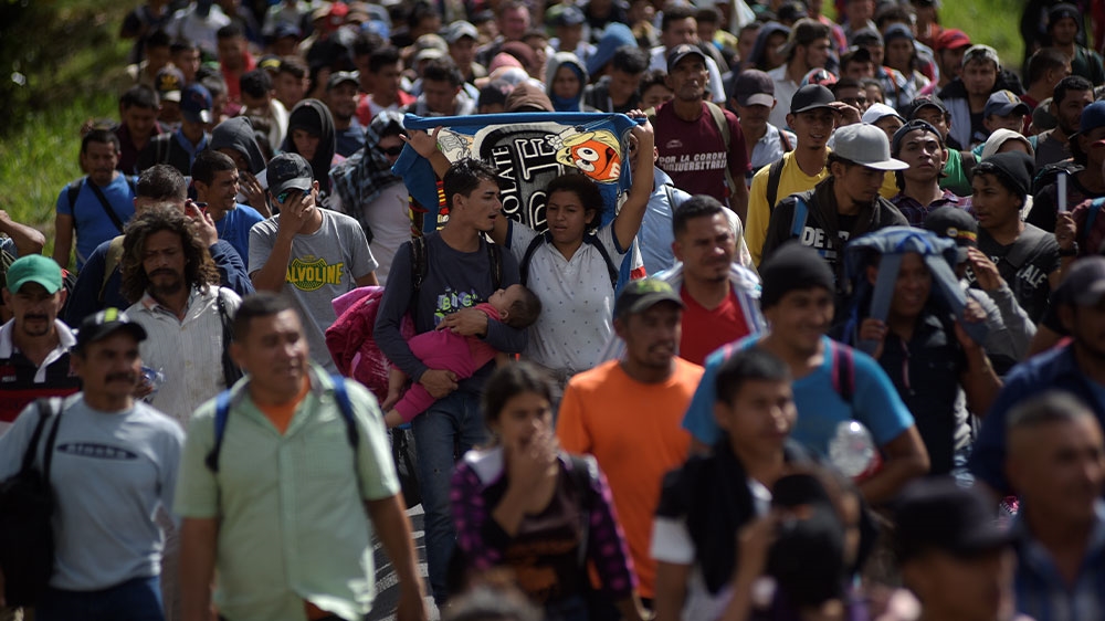 Honduran migrants travelling in a caravan walking in a group heading towards the United States, after breaking a blockade erected by Guatemalan police officers in Esquipulas, Guatemala