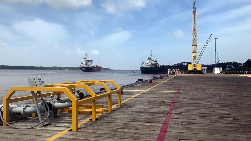 Vessels carrying supplies for an offshore oil platform operated by Exxon Mobil are seen at the Guyana Shore Base Inc wharf on the Demerara River, south of Georgetown, Guyana