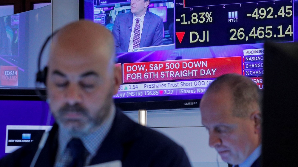 Traders work on the floor at the New York Stock Exchange