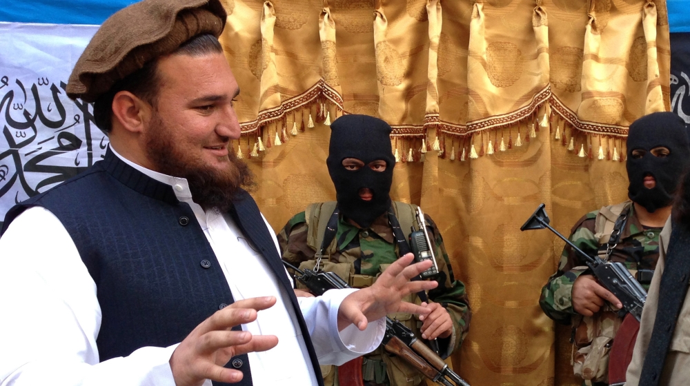 Tehreek-e-Taliban Pakistan (TTP) spokesman Ehsanullah Ehsan (L) talks with new TTP member Adnan Rasheed following a press conference in Shabtoi, a village in Pakistan''s South Waziristan, on February 2