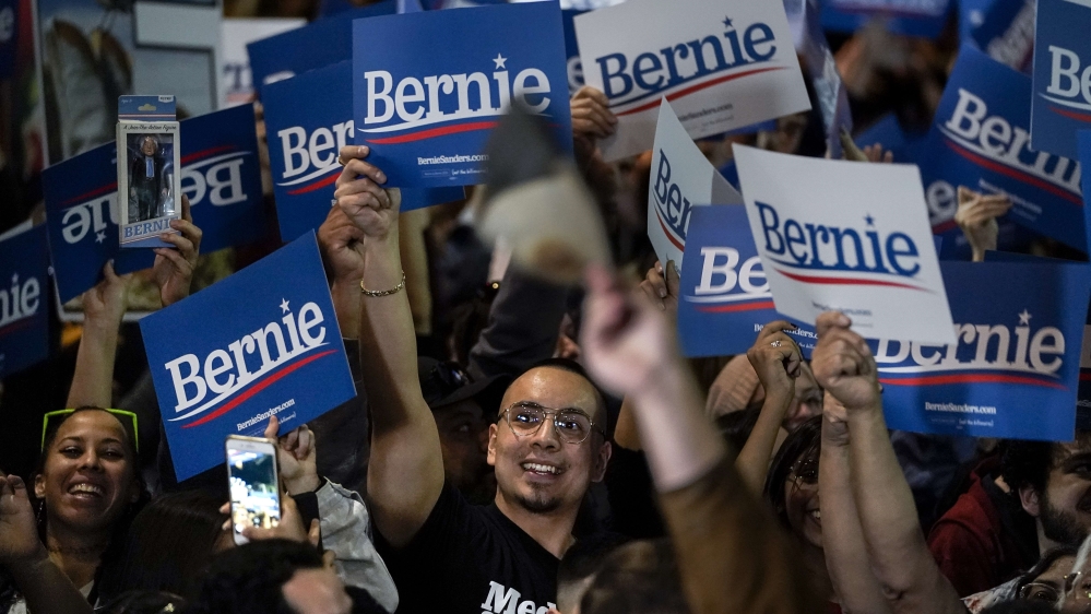 Supporters cheer as they watch returns from the Nevada caucuses while waiting for Bernie Sanders to arrive for a campaign rally at Cowboys Dancehall on February 22, 2020, in San Antonio, Texas