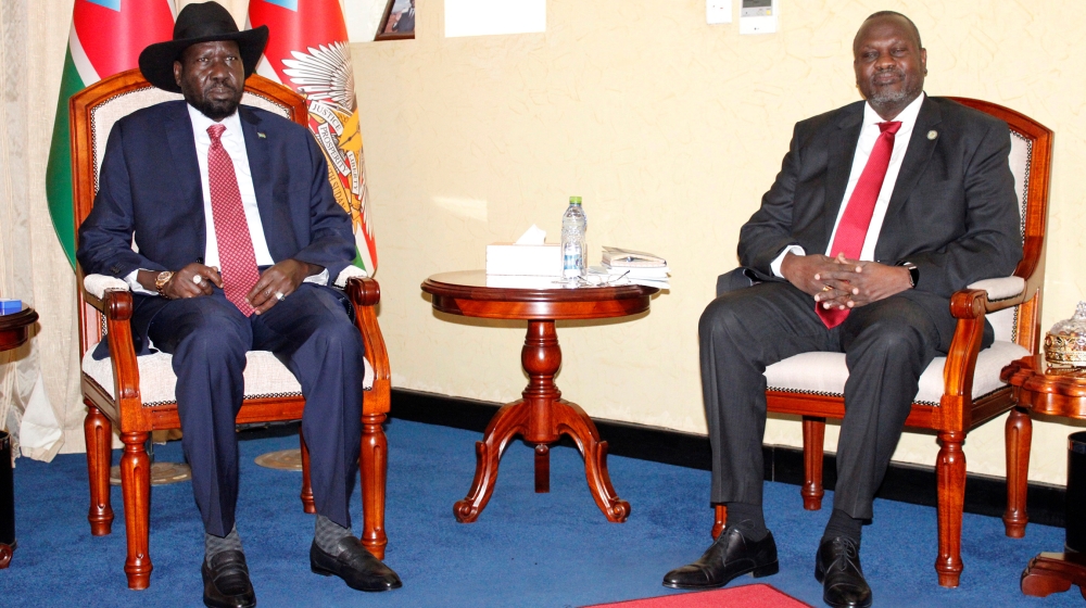 South Sudan''s President Salva Kiir Mayardit(L) and former vice president and rebel leader Riek Machar pose for pictures before their meeting in which they have reached a deal to form a long-delayed un