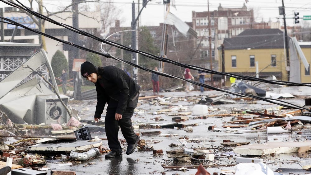 A man walks through storm debris following a deadly tornado in Nashville, Tennessee on Tuesday