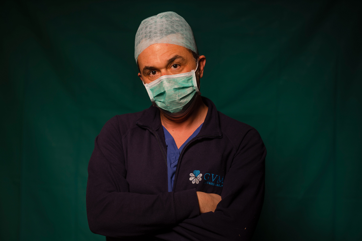 Mirko Perruzza, 43, a nurse at Rome''s COVID 3 Spoke Casalpalocco Clinic, poses for a portrait, Friday, March 27, 2020, during a break in his daily shift. Their eyes are tired. Their cheekbones are rub